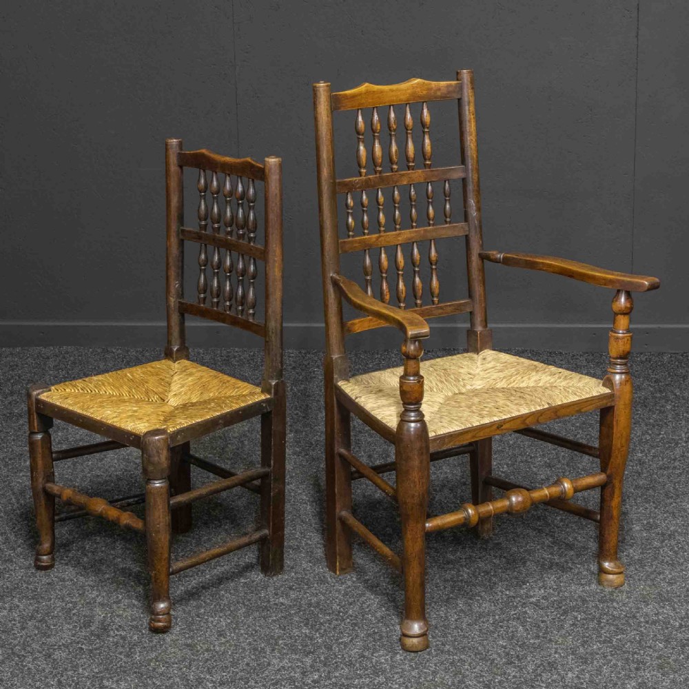 A set of eight dark oak Lancashire spindleback dining chairs with hand-woven rush seats, comprising six side chairs and two carver armchairs. View VII