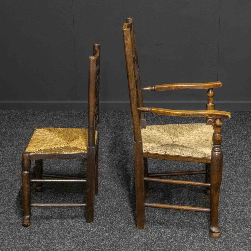 A set of eight dark oak Lancashire spindleback dining chairs with hand-woven rush seats, comprising six side chairs and two carver armchairs. View IX