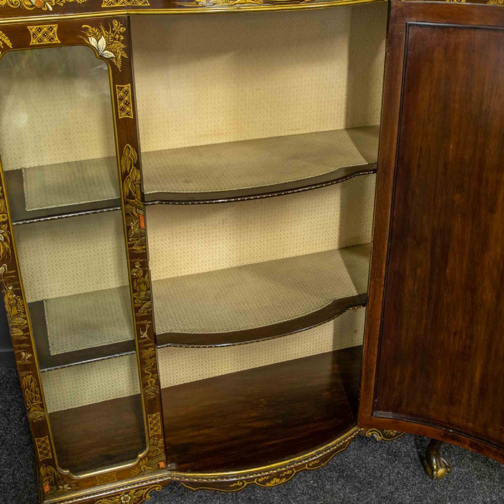 An antique dark timber Chinoiserie display cabinet featuring gold lacquered oriental scenes, glazed side panels, and carved cabriole legs with ball and claw feet. View III