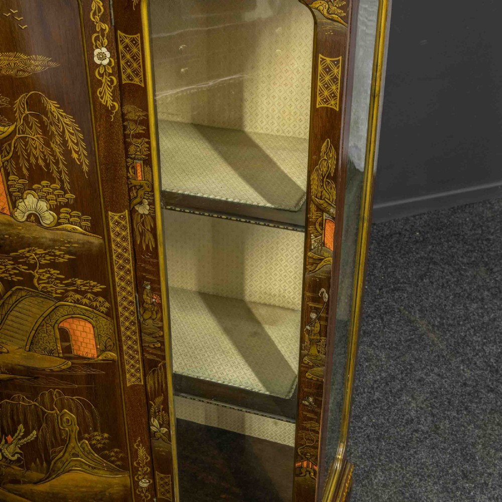 An antique dark timber Chinoiserie display cabinet featuring gold lacquered oriental scenes, glazed side panels, and carved cabriole legs with ball and claw feet. View VI