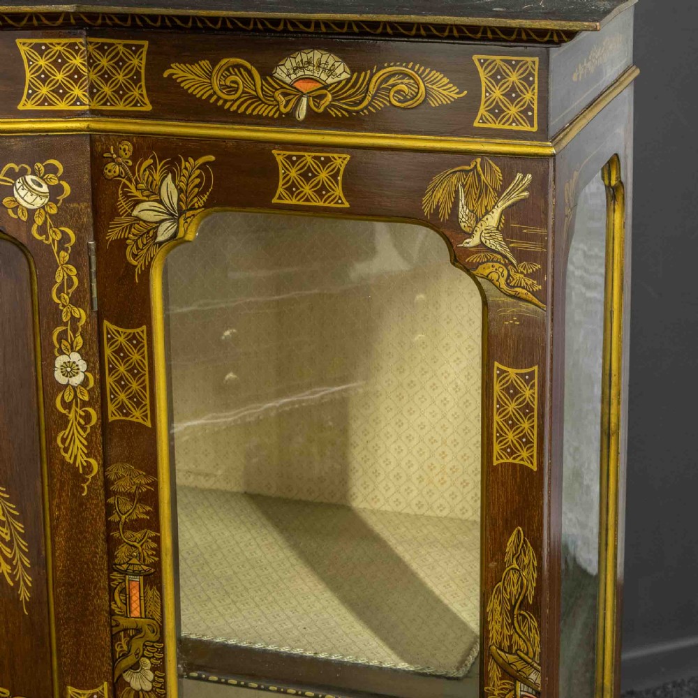 An antique dark timber Chinoiserie display cabinet featuring gold lacquered oriental scenes, glazed side panels, and carved cabriole legs with ball and claw feet. View VIII