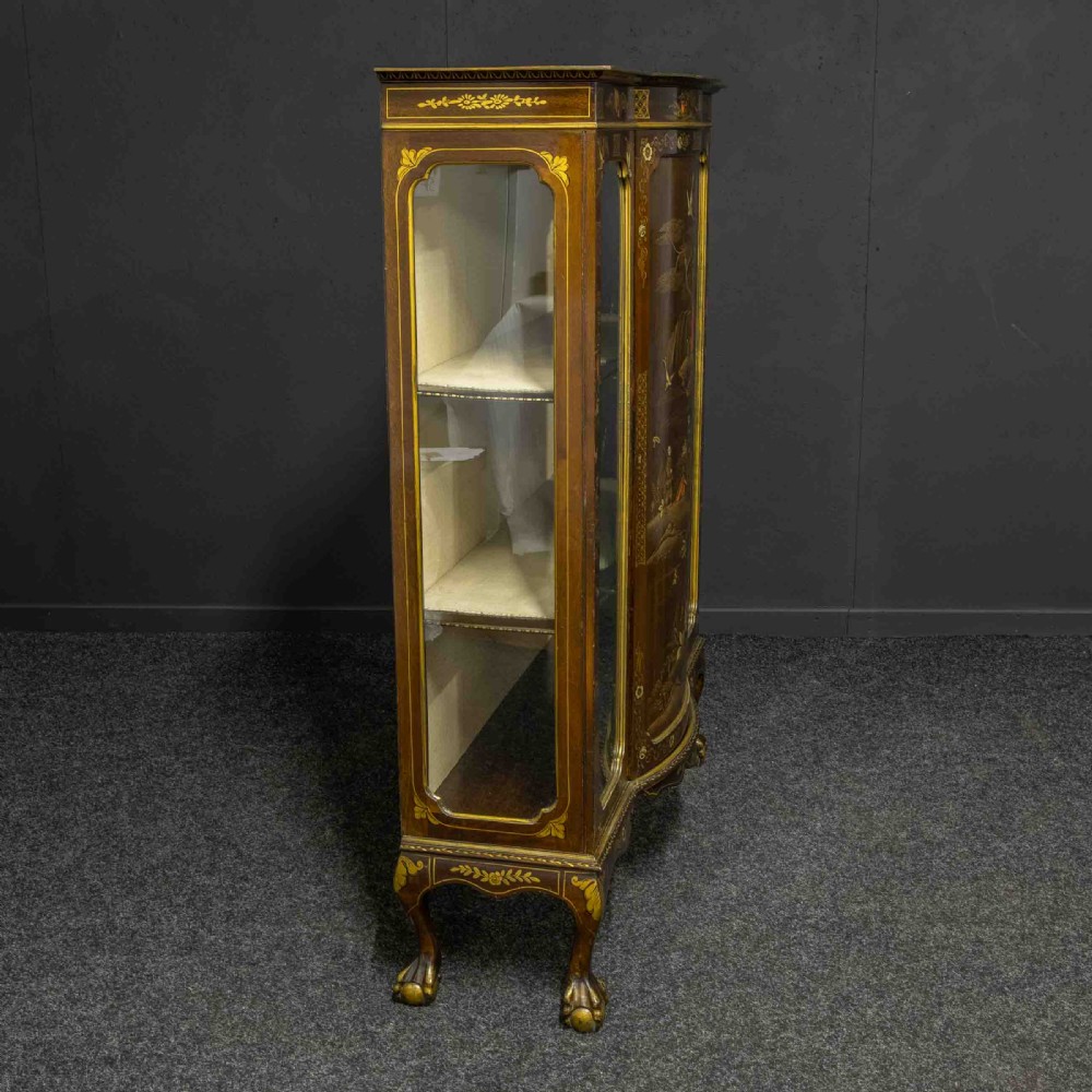 An antique dark timber Chinoiserie display cabinet featuring gold lacquered oriental scenes, glazed side panels, and carved cabriole legs with ball and claw feet. View XVI