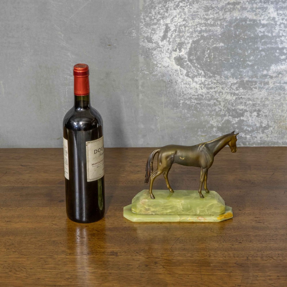 A patinated bronze stallion sculpture resting on a faceted pale green onyx base. View II