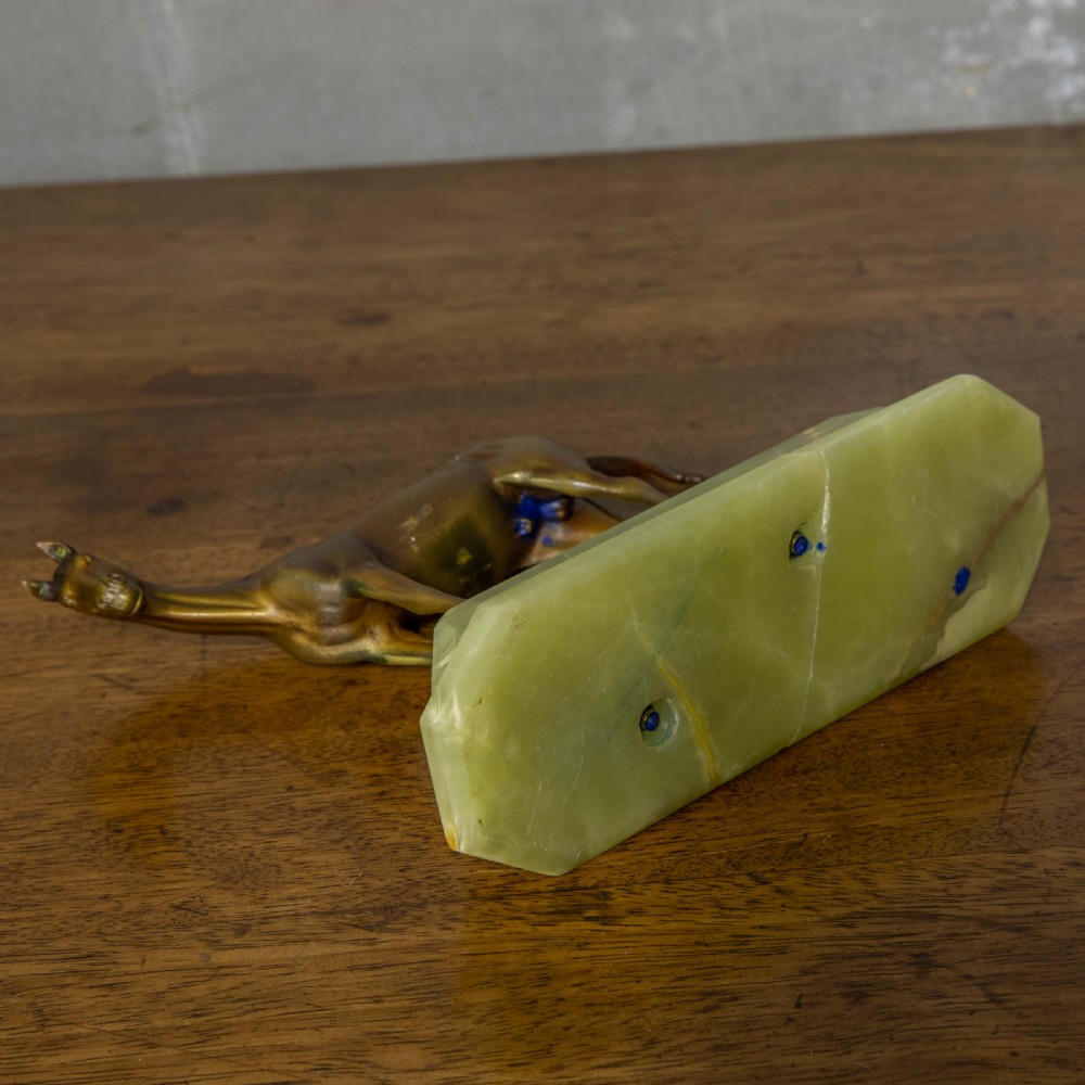A patinated bronze stallion sculpture resting on a faceted pale green onyx base. View VIII