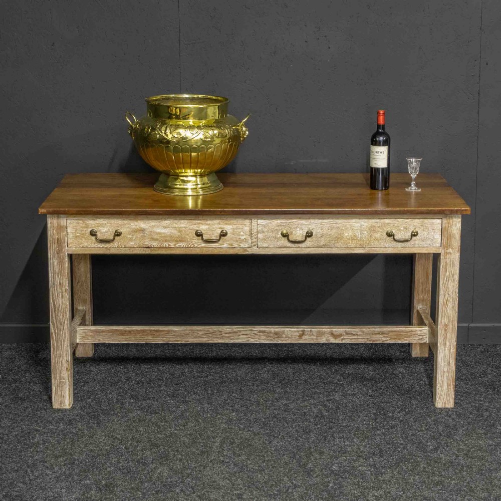 A polished brass planter featuring embossed floral motifs, gadrooned lower body detailing, twin side handles, and a raised pedestal base. View VI
