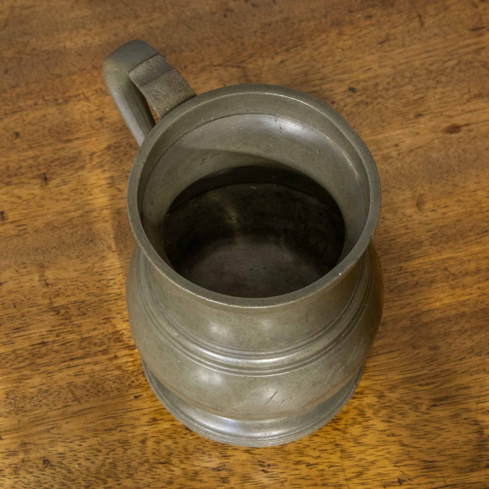 A Victorian two-pint pewter tankard with a baluster-shaped body, flared rim, curved handle, and circular pedestal base. View VII