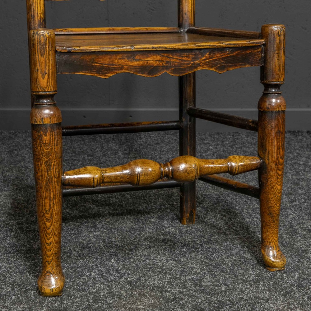 A set of eight Georgian oak dining chairs featuring wavy ladderback splats, solid wooden seats, and turned front stretchers. View IX