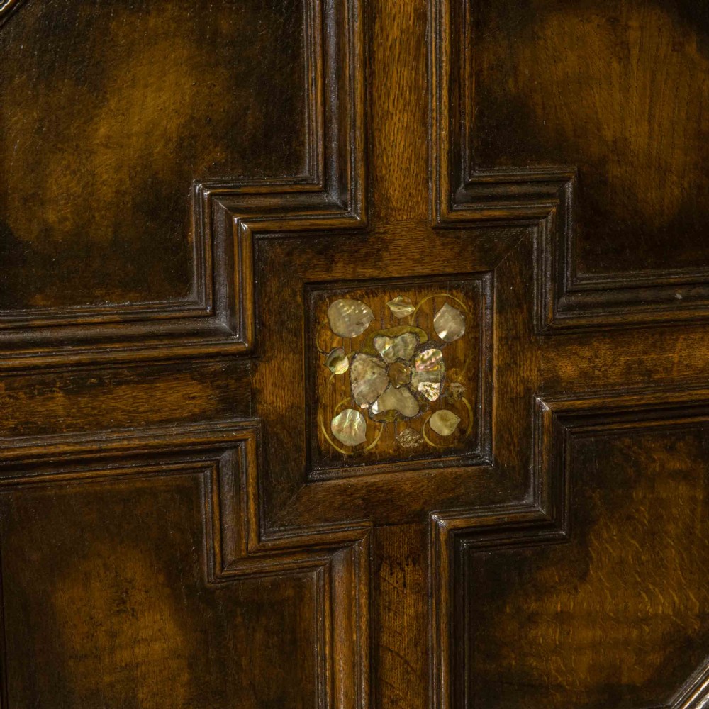 A dark oak Jacobean dresser featuring geometric mouldings, mother-of-pearl inlays, arched panels, turned split spindles, and lower drawers. View IX