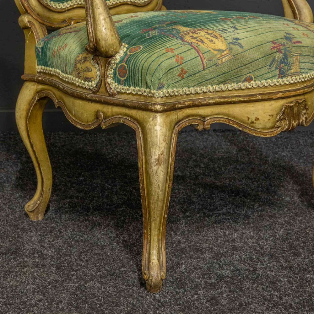 A 19th-century French giltwood fauteuil open armchair featuring carved shell motifs, cabriole legs, and patterned green upholstery. View II