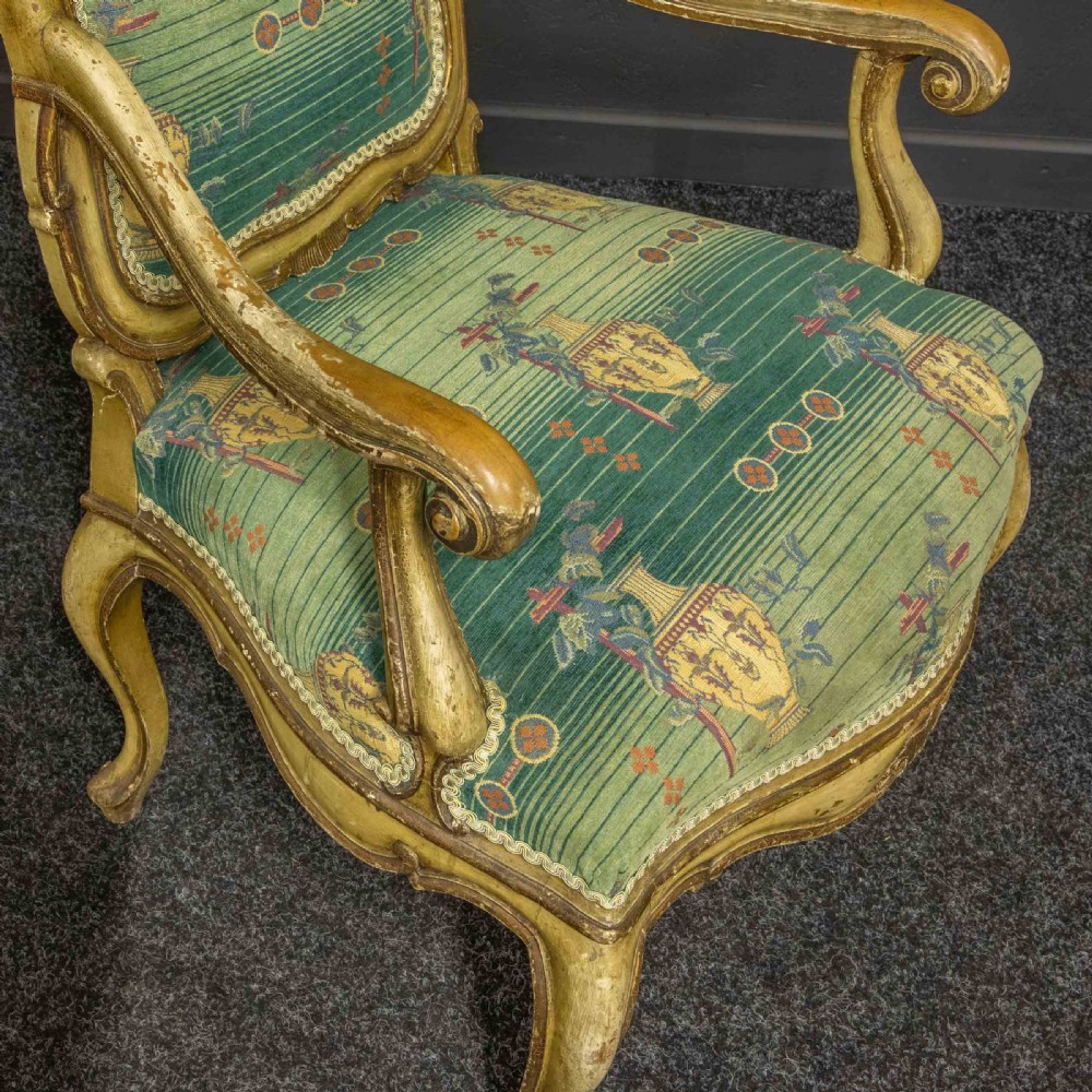 A 19th-century French giltwood fauteuil open armchair featuring carved shell motifs, cabriole legs, and patterned green upholstery. View IV