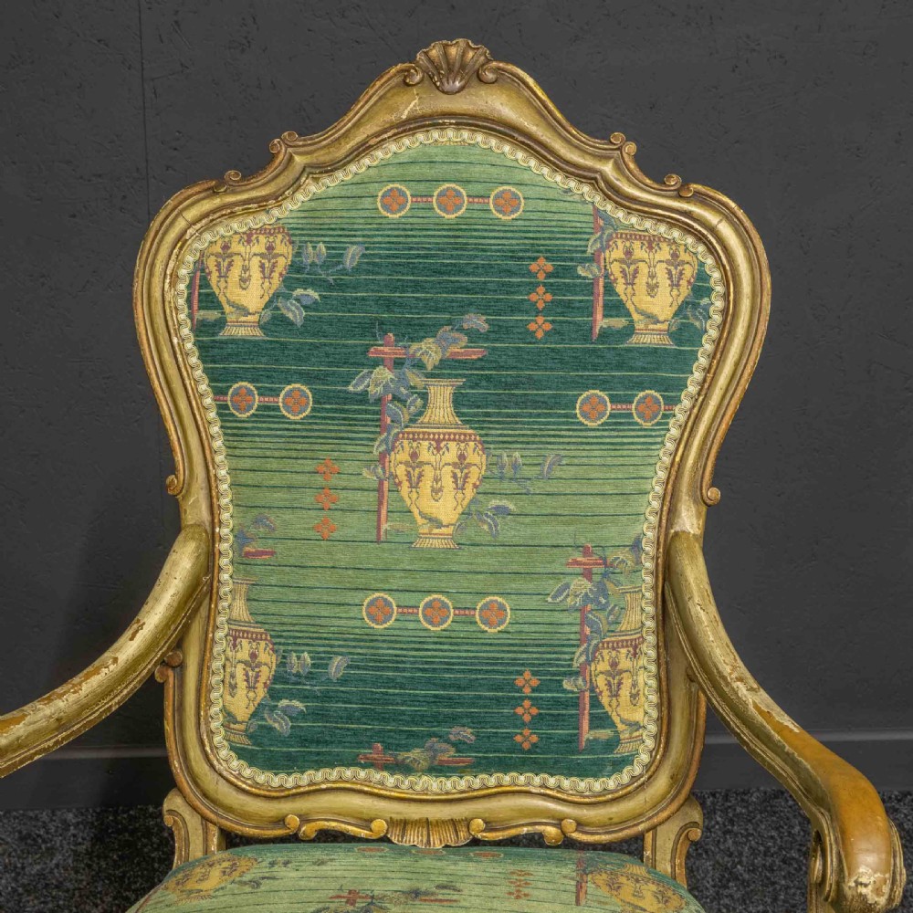 A 19th-century French giltwood fauteuil open armchair featuring carved shell motifs, cabriole legs, and patterned green upholstery. View VI