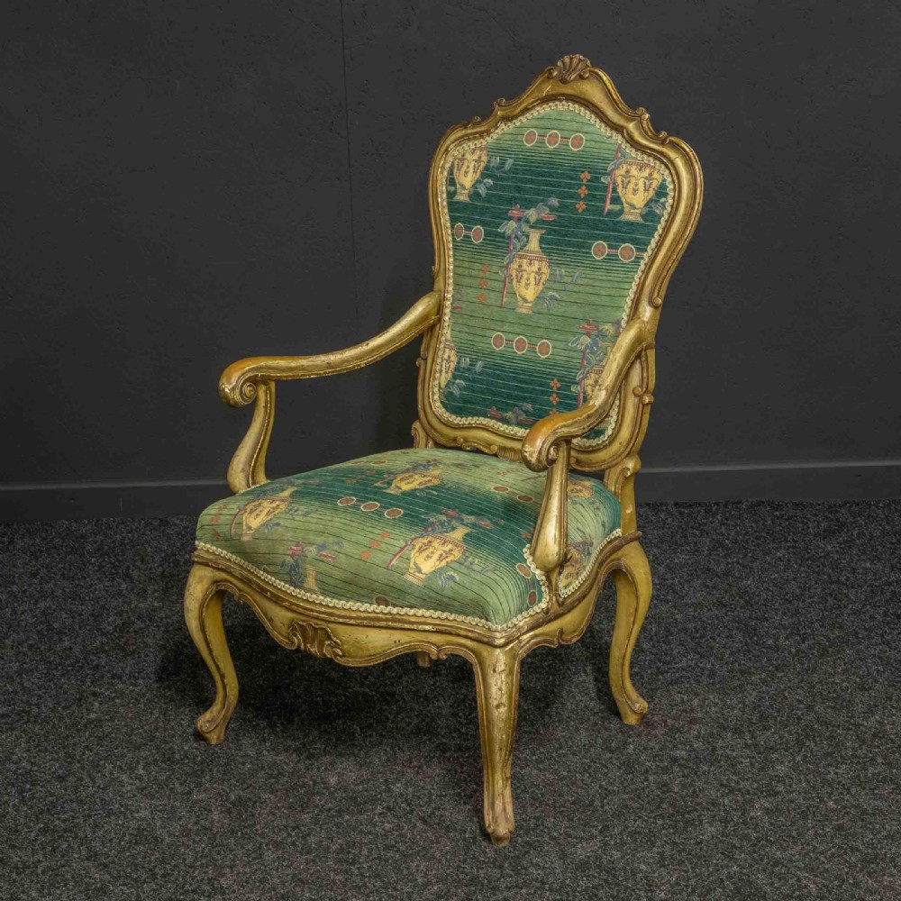 A 19th-century French giltwood fauteuil open armchair featuring carved shell motifs, cabriole legs, and patterned green upholstery. View IX