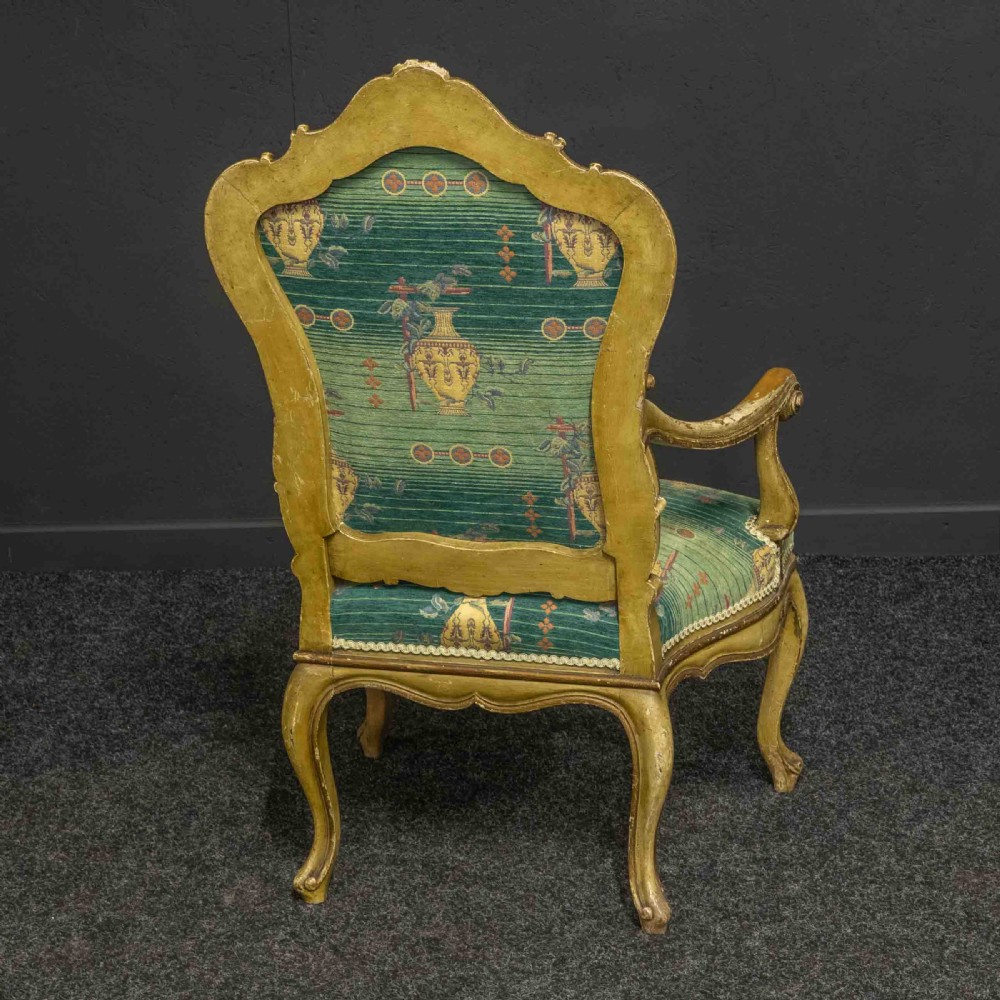 A 19th-century French giltwood fauteuil open armchair featuring carved shell motifs, cabriole legs, and patterned green upholstery. View XI