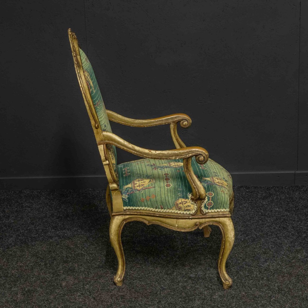 A 19th-century French giltwood fauteuil open armchair featuring carved shell motifs, cabriole legs, and patterned green upholstery. View XII