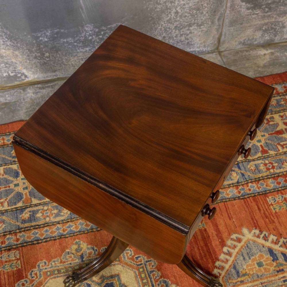 A Regency mahogany drop-leaf worktable featuring two drawers with wooden knobs, a turned pedestal column, and tripod legs with brass paw feet. View IV