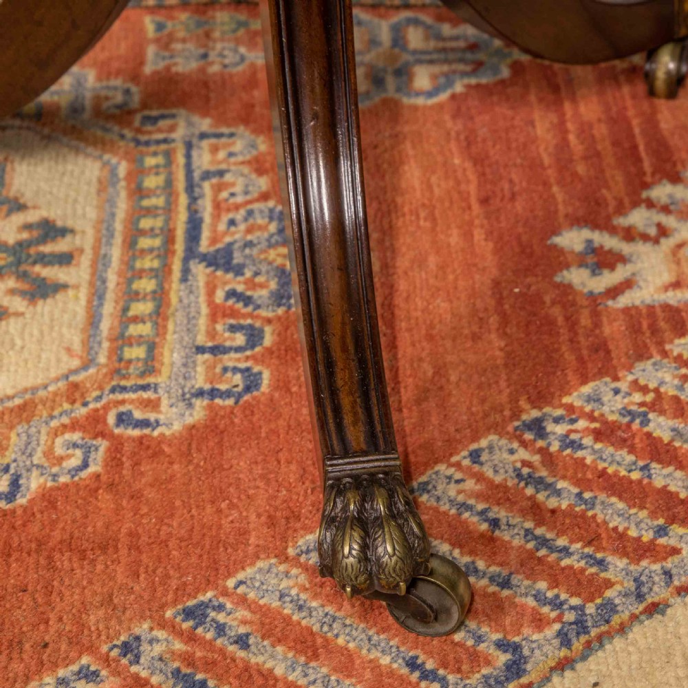 A Regency mahogany drop-leaf worktable featuring two drawers with wooden knobs, a turned pedestal column, and tripod legs with brass paw feet. View XIII