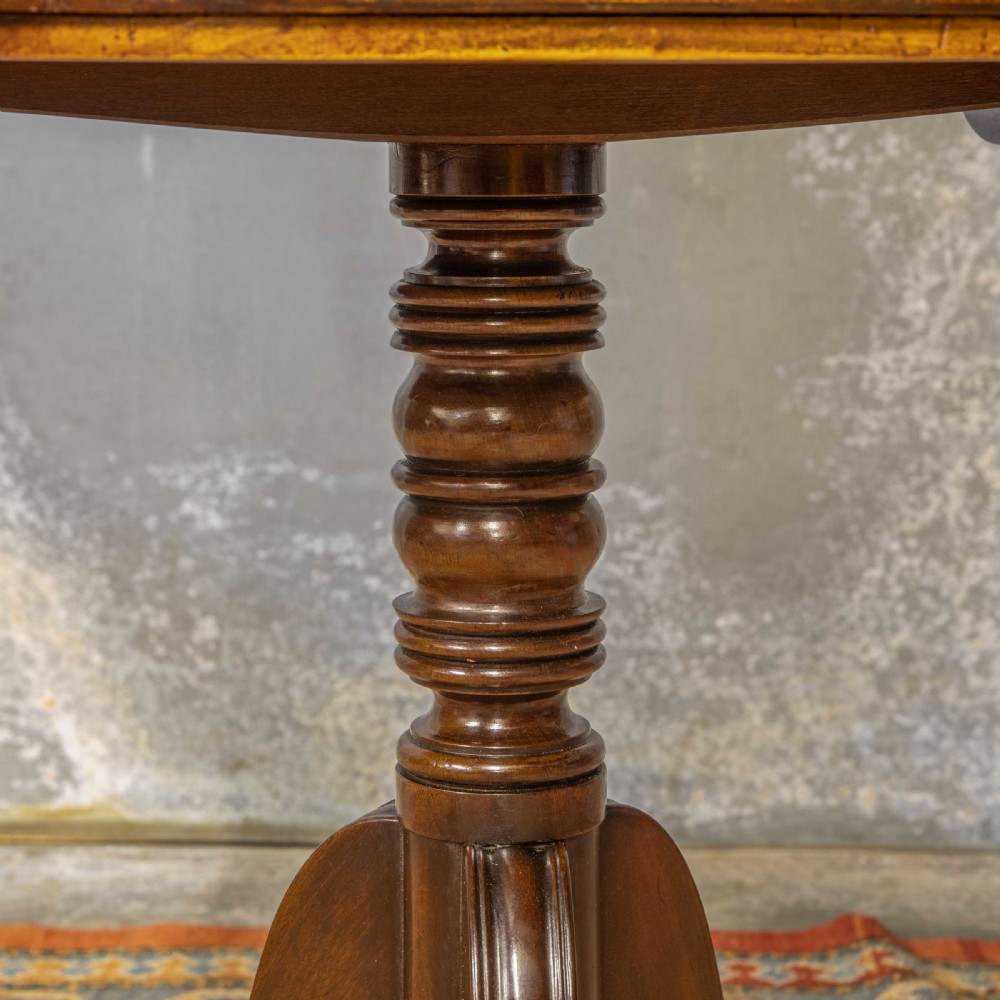 A Regency mahogany drop-leaf worktable featuring two drawers with wooden knobs, a turned pedestal column, and tripod legs with brass paw feet. View XIV