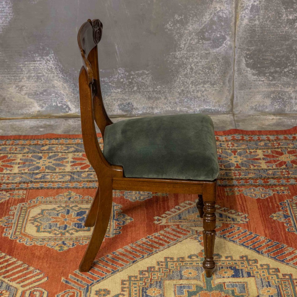 A set of six William IV mahogany dining chairs featuring carved top rails, turned front legs, and green velvet upholstered seats. View VIII