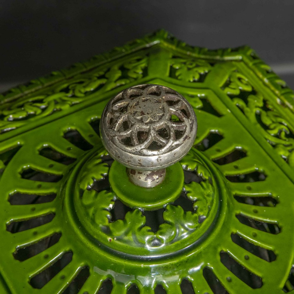 A tall rectangular green enamelled cast iron stove with elaborate openwork pierced filigree patterning and scrolled feet. View XV