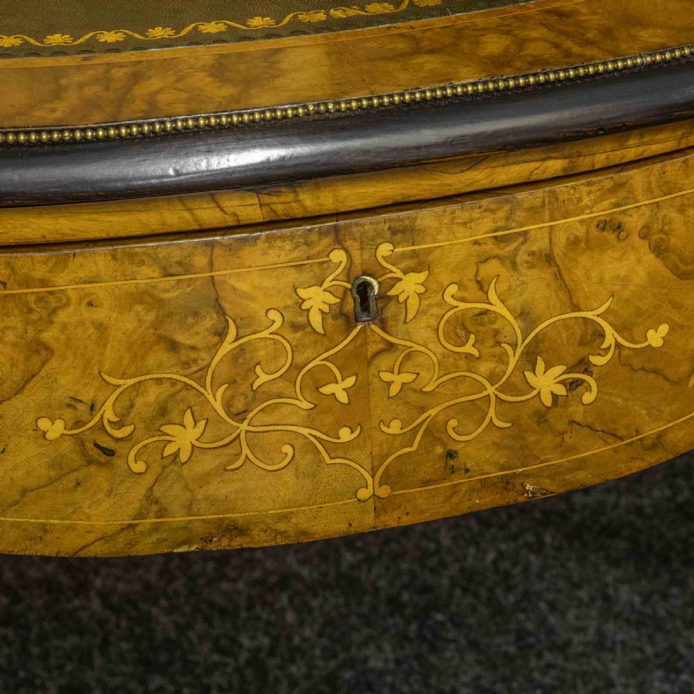 A Victorian burr walnut bonheur de jour featuring floral marquetry inlays, gilt brass mounts, cabriole legs, and a green leather writing surface. View XV