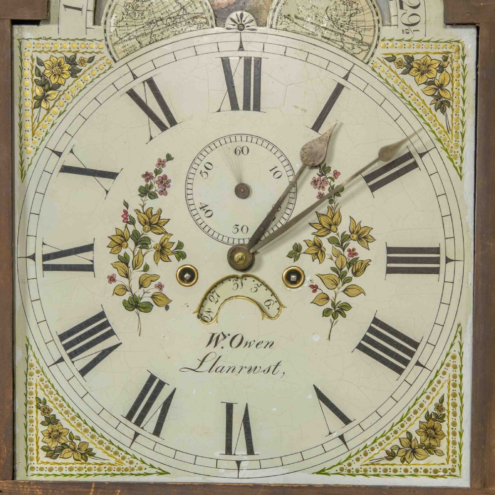 A Georgian mahogany longcase clock featuring a swan-neck pediment with a brass finial, spiral quarter columns, and a hand-painted arch dial. View VIII