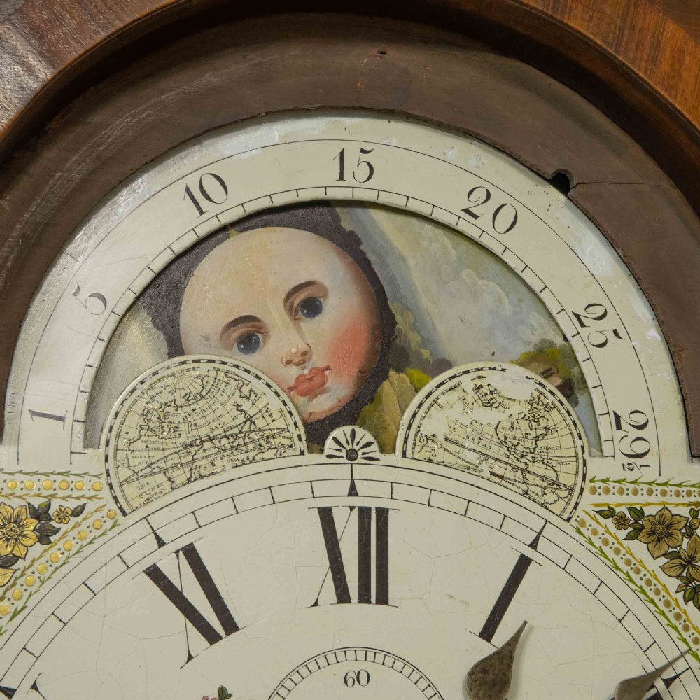 A Georgian mahogany longcase clock featuring a swan-neck pediment with a brass finial, spiral quarter columns, and a hand-painted arch dial. View IX