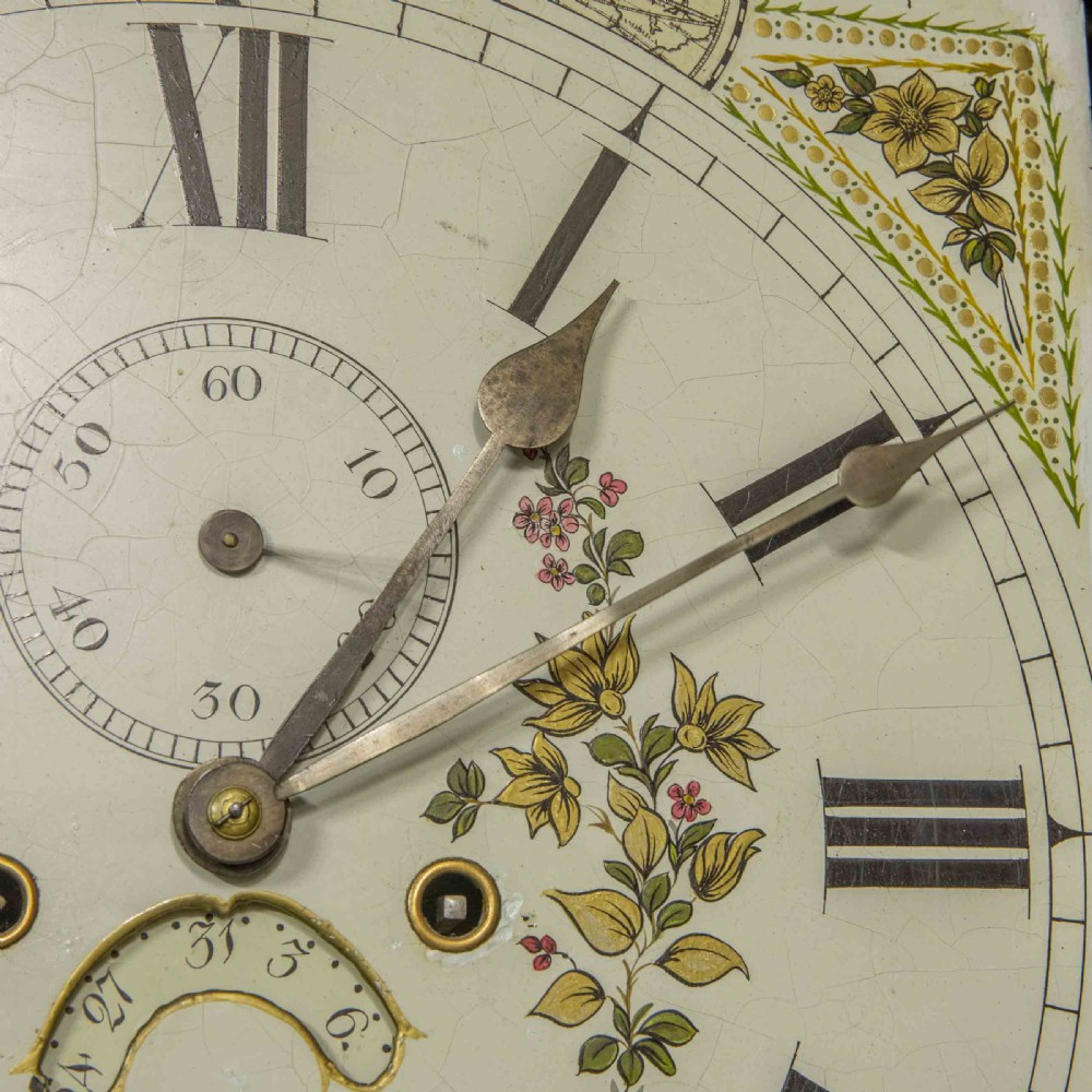 A Georgian mahogany longcase clock featuring a swan-neck pediment with a brass finial, spiral quarter columns, and a hand-painted arch dial. View XI