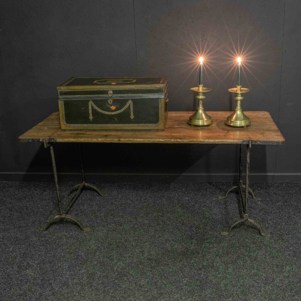 A pair of Victorian solid brass pricket candlesticks featuring wide circular drip pans, turned knopped stems, and broad bell-shaped bases. View II