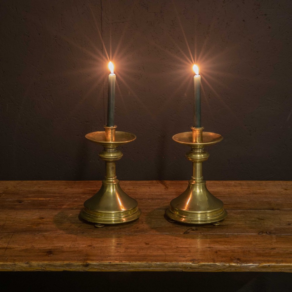 A pair of Victorian solid brass pricket candlesticks featuring wide circular drip pans, turned knopped stems, and broad bell-shaped bases. View III
