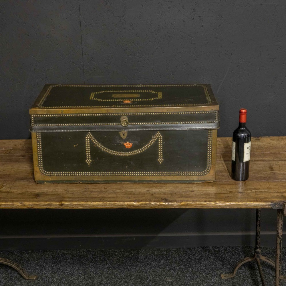 An early nineteenth-century dark green leather coaching trunk featuring brass stud embellishments in a festoon pattern and side carrying handles. View II