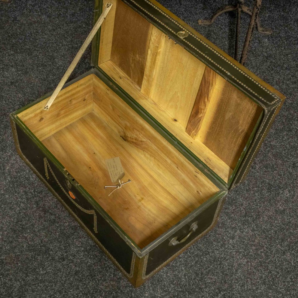 An early nineteenth-century dark green leather coaching trunk featuring brass stud embellishments in a festoon pattern and side carrying handles. View IV