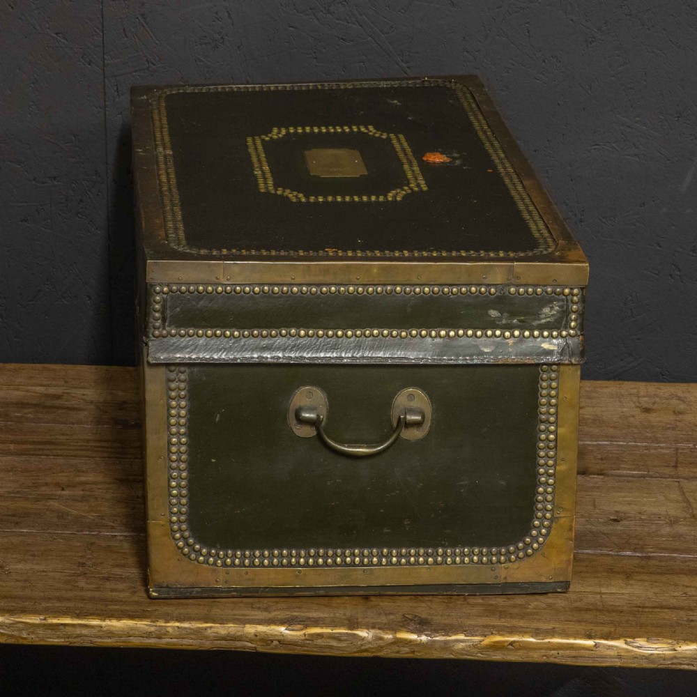 An early nineteenth-century dark green leather coaching trunk featuring brass stud embellishments in a festoon pattern and side carrying handles. View V