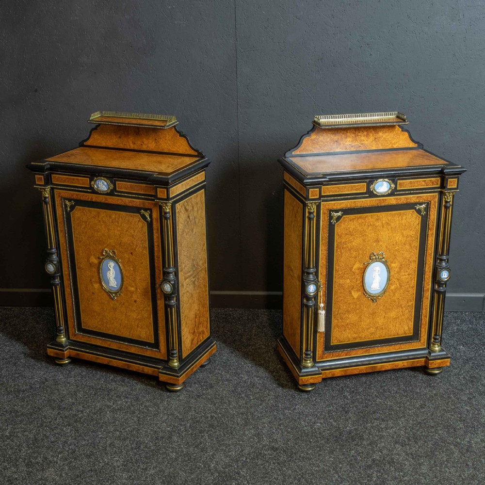 A pair of Victorian ebonised and amboyna pier cabinets featuring raised brass galleries and central blue porcelain Jasperware plaques. View III