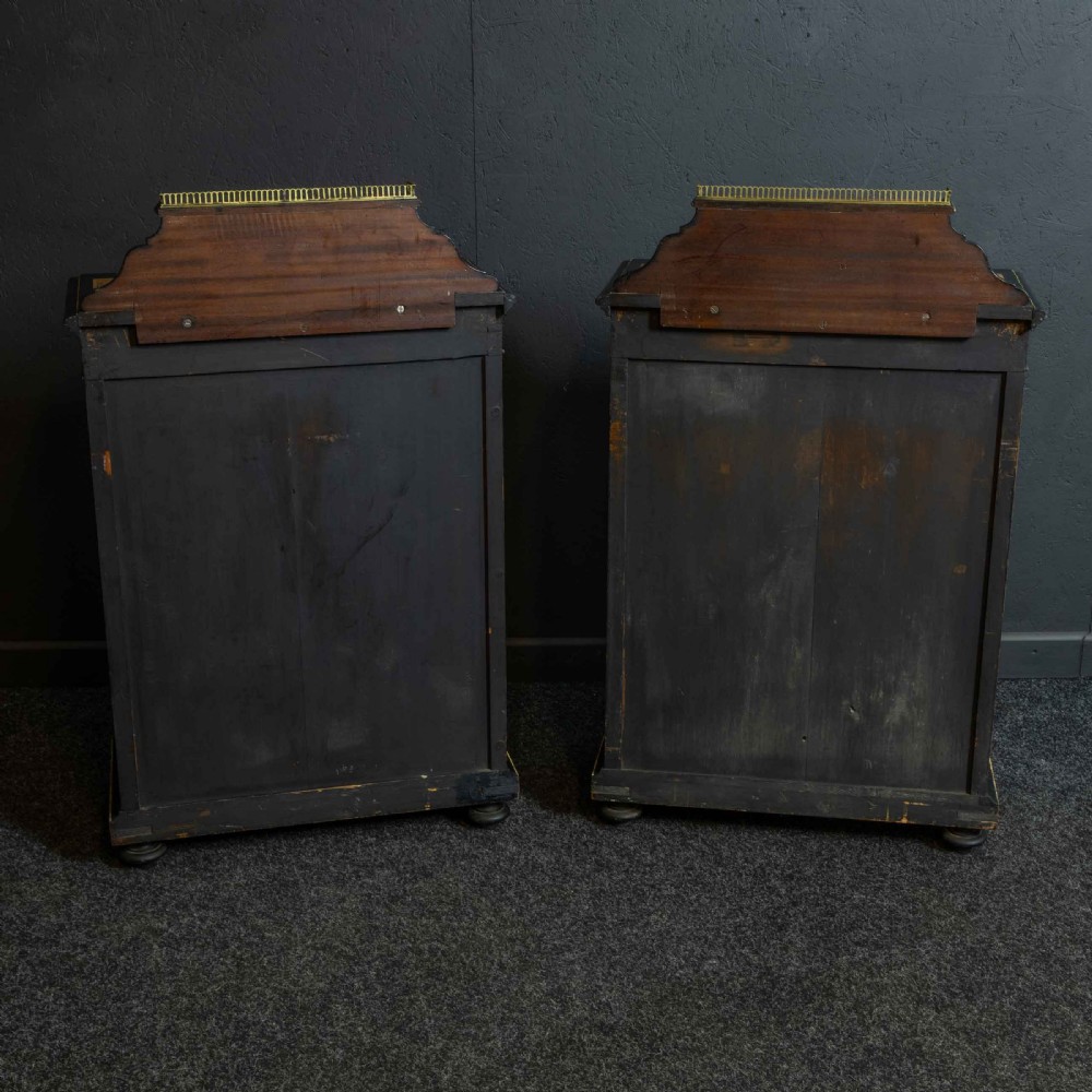 A pair of Victorian ebonised and amboyna pier cabinets featuring raised brass galleries and central blue porcelain Jasperware plaques. View VIII