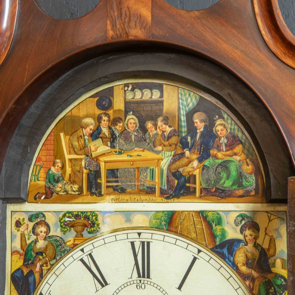 An antique Scottish mahogany longcase clock featuring a swan neck pediment, turned hood columns, flame mahogany trunk door, and a hand-painted dial. View III