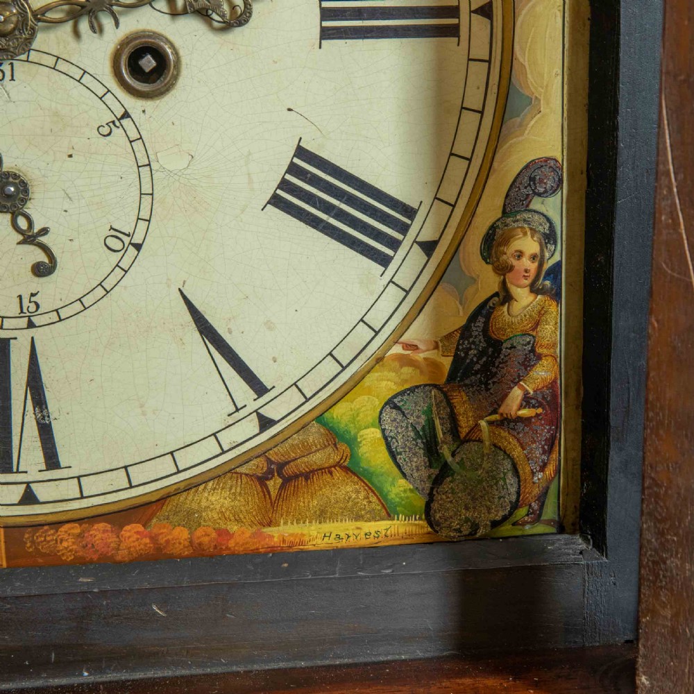 An antique Scottish mahogany longcase clock featuring a swan neck pediment, turned hood columns, flame mahogany trunk door, and a hand-painted dial. View VII
