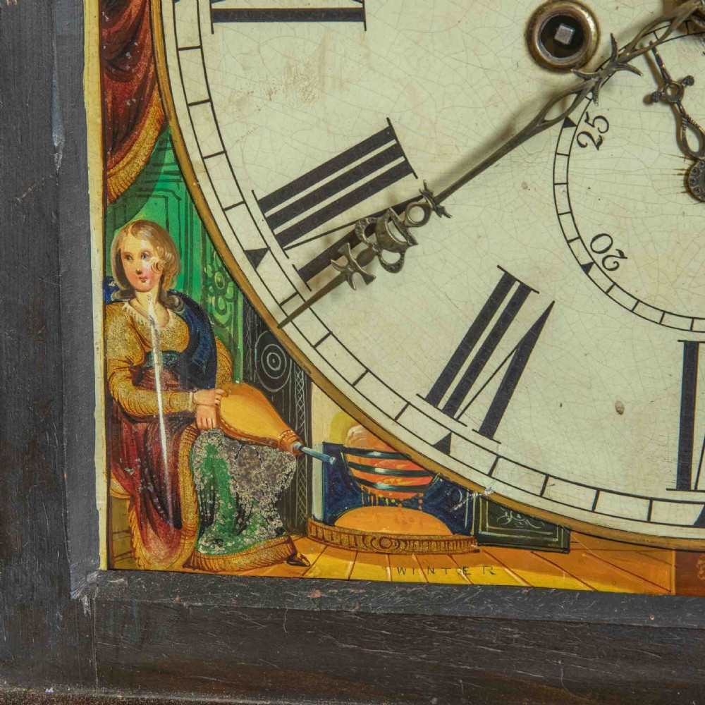 An antique Scottish mahogany longcase clock featuring a swan neck pediment, turned hood columns, flame mahogany trunk door, and a hand-painted dial. View VIII