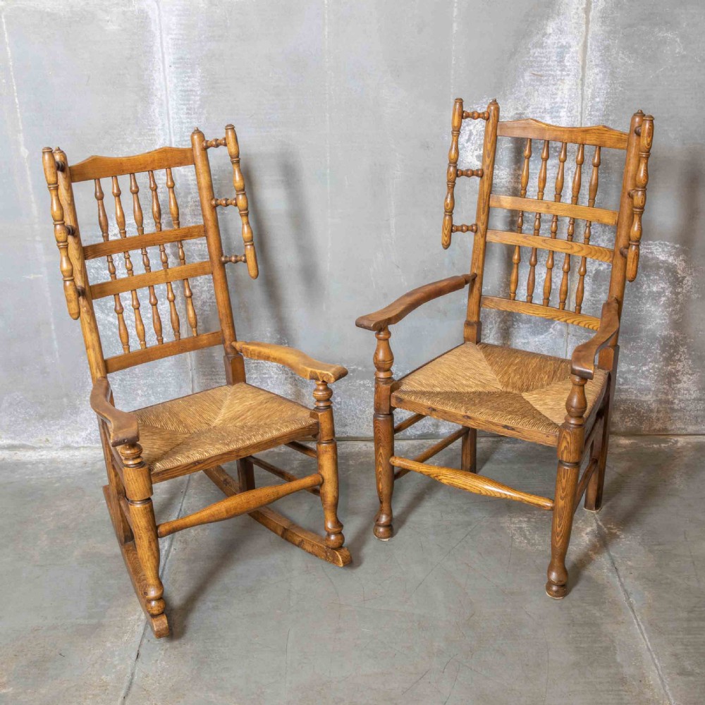A pair of matching Victorian country armchairs in warm wood with woven rush seats and turned spindle backs, including one rocking chair and one static armchair. View VII