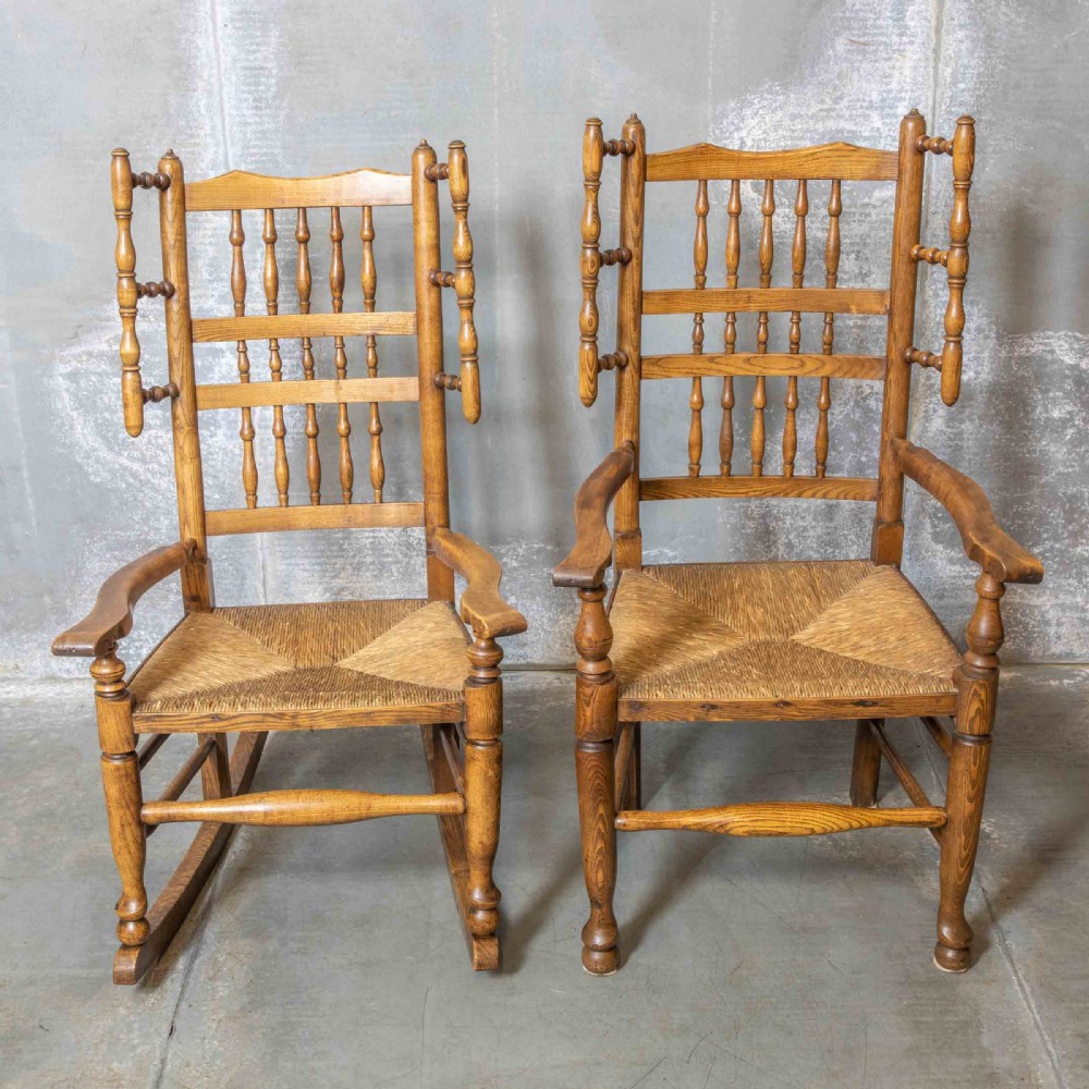 A pair of matching Victorian country armchairs in warm wood with woven rush seats and turned spindle backs, including one rocking chair and one static armchair. View VIII