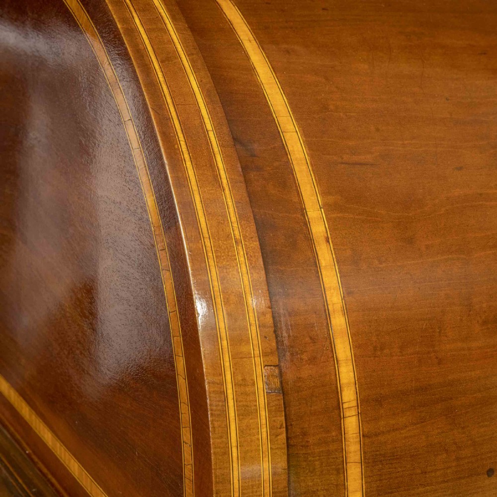 An antique mahogany cylinder desk featuring inlaid satinwood borders, a pull-out leather writing slope, fitted pigeonholes, and twin drawer pedestals. View VIII