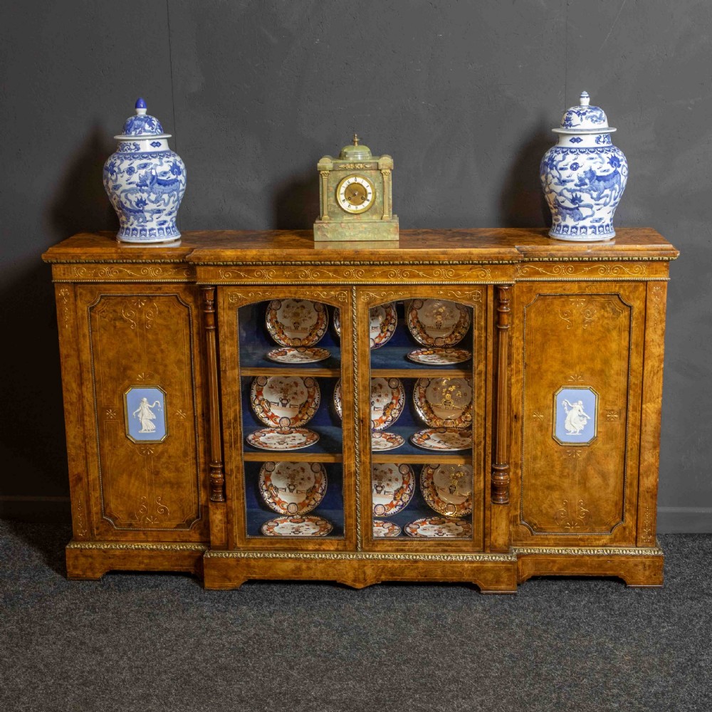 A Victorian burr walnut credenza featuring twin glazed central doors flanked by inlaid cupboard doors set with blue porcelain plaques. View II