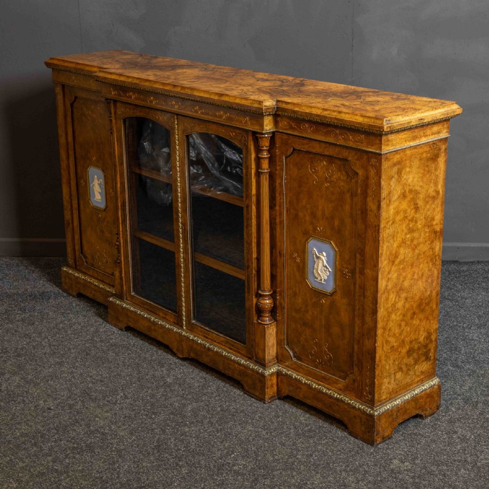 A Victorian burr walnut credenza featuring twin glazed central doors flanked by inlaid cupboard doors set with blue porcelain plaques. View VII