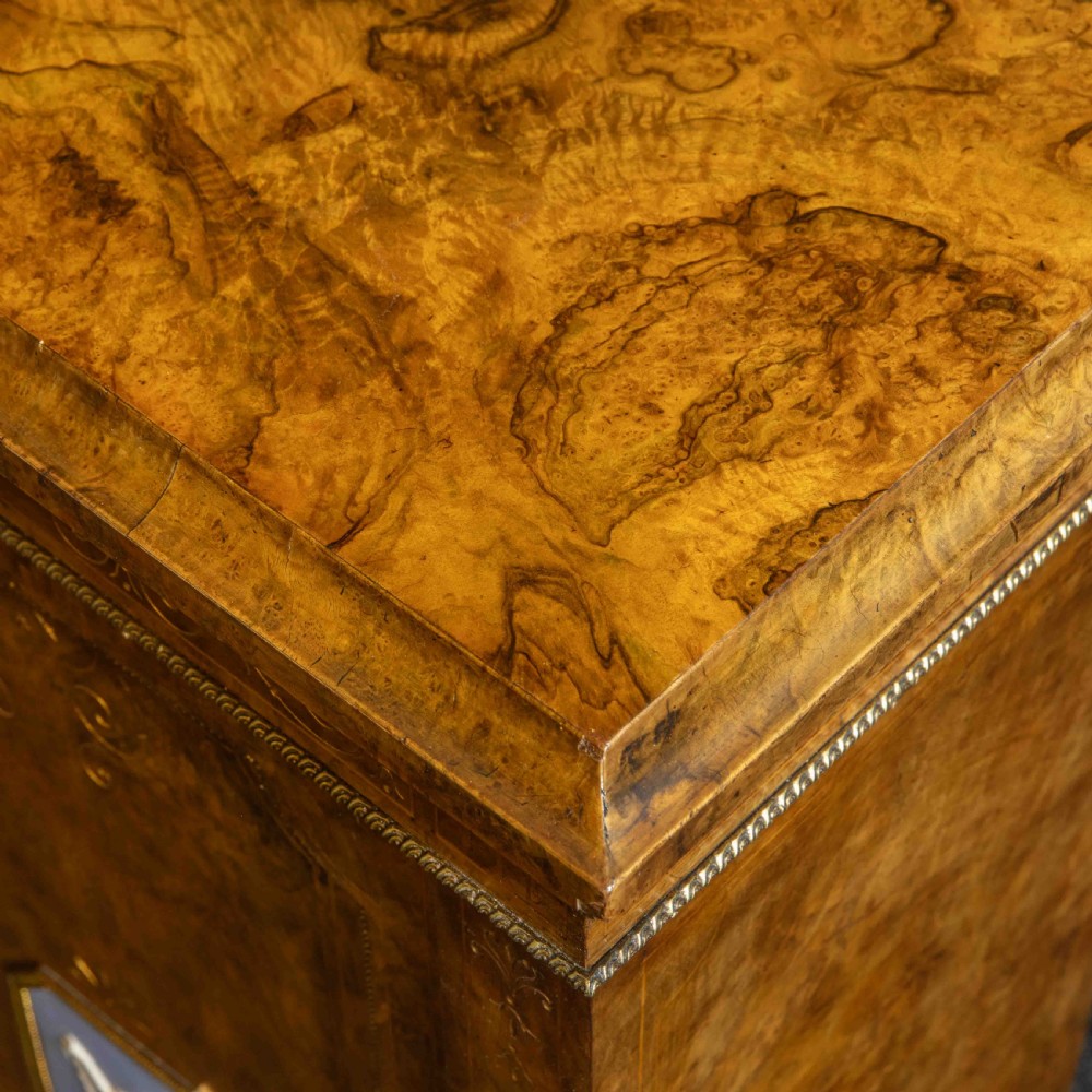 A Victorian burr walnut credenza featuring twin glazed central doors flanked by inlaid cupboard doors set with blue porcelain plaques. View IX