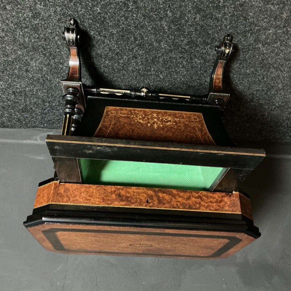 An ebonised Victorian games and sewing table featuring a fold-out top inlaid with chess and backgammon boards supported on turned twin columns. View VI