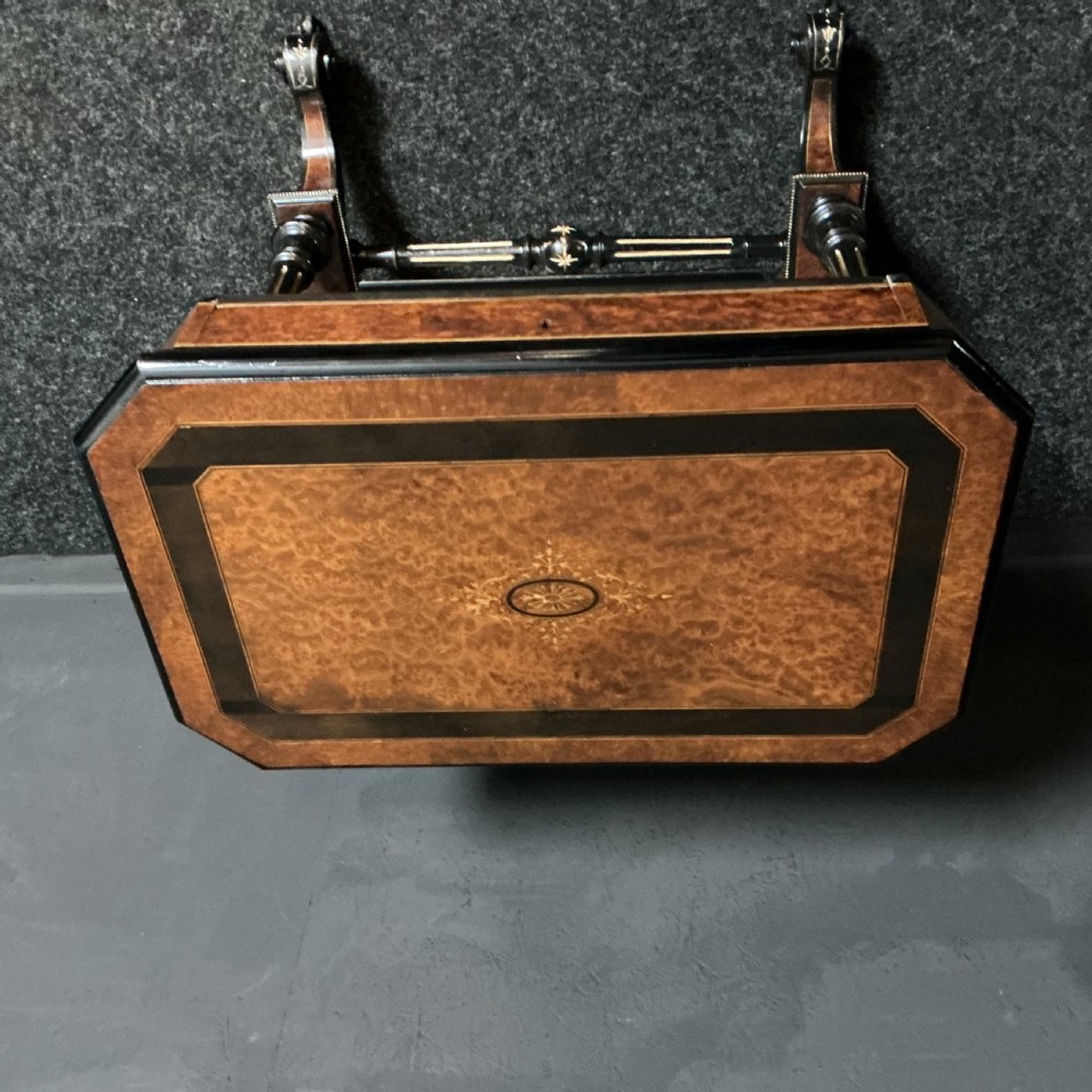 An ebonised Victorian games and sewing table featuring a fold-out top inlaid with chess and backgammon boards supported on turned twin columns. View VII