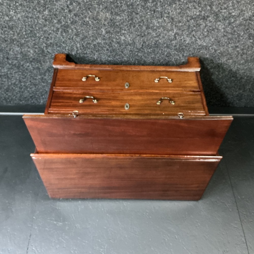 A Georgian mahogany chest of drawers featuring four graduated drawers with brass swan-neck handles, escutcheons, and bracket feet. View XII