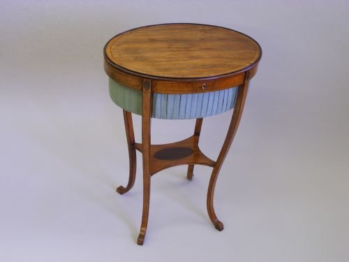 A Sheraton Period Satinwood and Kingwood Oval Work Table.