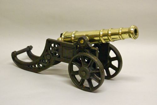 A Victorian Brass Ornamental Cannon on Cast Iron Carriage.