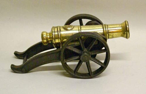 A Victorian Brass Ornamental Cannon on Cast Iron Carriage.