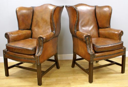 A Pair of Georgian Style Mahogany and Leather Wing Chairs